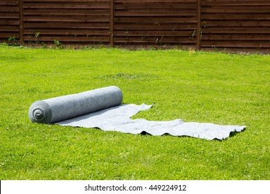 Gray Geotextile Roll Lying On The Lawn