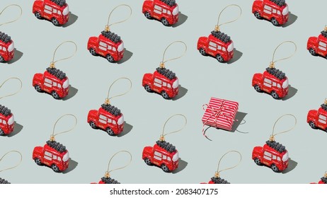 Gray green background pattern with Christmas, New Year symbol attribute objects and symbolic items concept. Small red English taxi car toy with ribbon, pink little gift box present. High quality photo