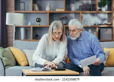 Gray Hair Mature Senior Couple Counting Money And Calculating Finances While Preparing Tax Report At Home Older Family With Payment Domestic Bill Checking Financial Documents, Planning Budget Together
