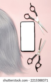 Gray Hair And Scissors For Cutting. Creating Beautiful Hairstyles. Pink Background. Top View. Flat Lay. Copy Space. Place For Text. Hairdresser. Phone With Blank White Screen. Mockup.