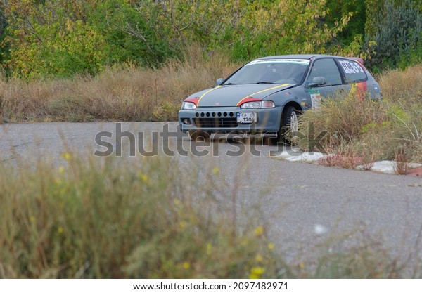 Gray Honda Civic car driving on the road. Tuned\
sports car.  Motion blur, defocus, noise, grain effect.  Nikolaev,\
Ukraine - 09 26 2021