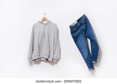 Gray hoodie sweatshirts with blue jeans on hanging
