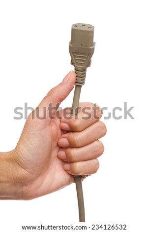 Gray IEC 3 pin power supply plug in female hand. Close up of woman's hand holding gray computer electric plug. Studio shot isolated on white.