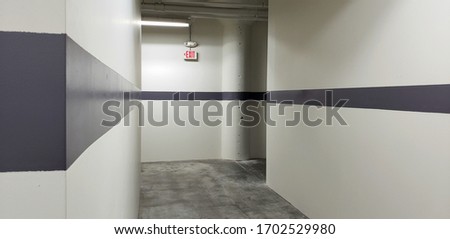 gray industrial hallway corridor with exit sign background