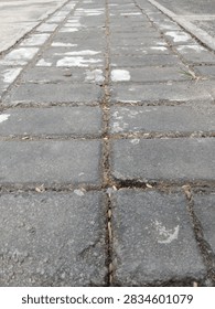 Gray interlocking concrete paver paths can be used for walking in home yards or outside buildings.