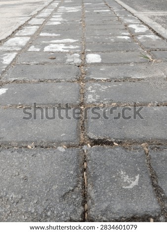 Gray interlocking concrete paver paths can be used for walking in home yards or outside buildings.