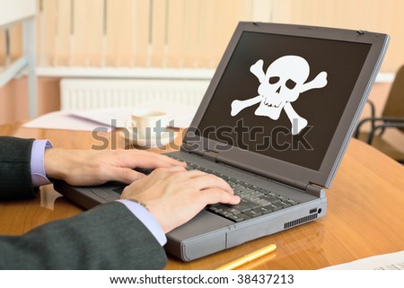 The gray laptop with the pirate software