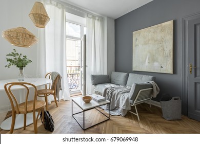 Gray Living Room With Couch, Table, Modern Painting And Balcony