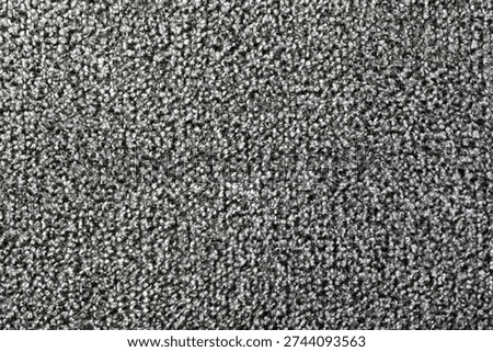 Gray loop pile carpet showing textile texture and abstract pattern