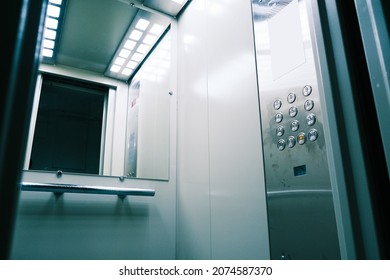 Gray Metal Elevator With A Mirror In Front Of The Door. New Elevator Inside