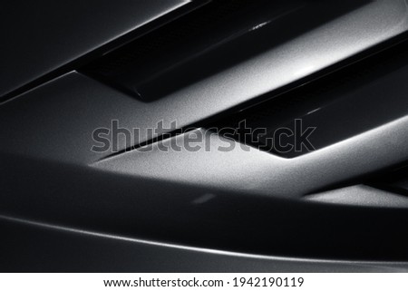Gray metallic sports car body parts, aerodynamics grille covers air intake system, close up photo, abstract modern car design template