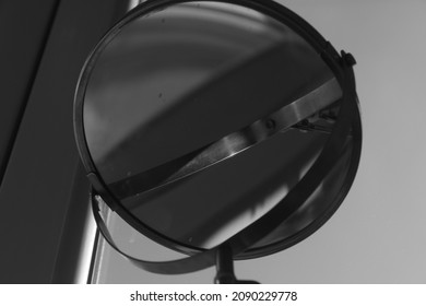 A gray mirror and wall