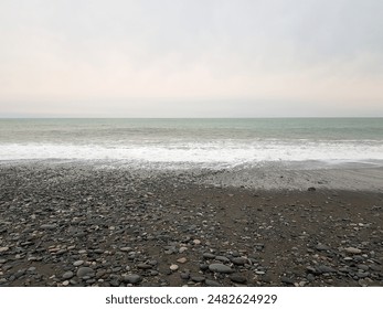 Gray nature background. Empty beach and sea