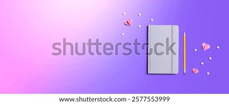 Gray notebook with paper hearts - flat lay