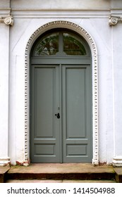 gray old door with white wall