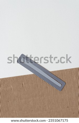 gray paper box with short line on a two dimensional blank paper and corrugated cardboard background