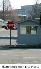 Gray Parking Lot Attendant Hut With Stop Sign