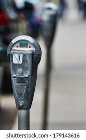 Gray parking meter in use in London, UK