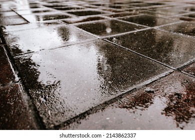 Gray paving stones after rain as background. Road surface in urban environment. Transport infrastructure. - Shutterstock ID 2143862337