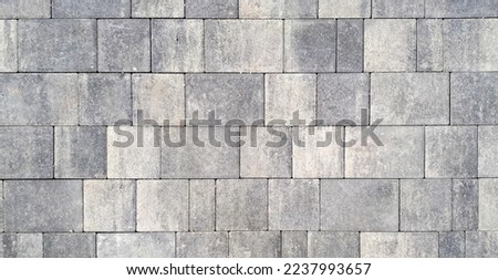 Gray paving stones. Paving surface road. Texture made of big gray cement bricks. Brick stone street road - pavement texture