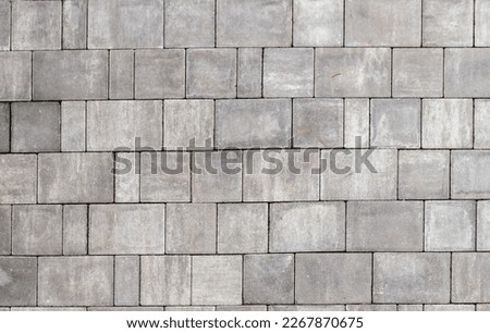 Gray paving stones texture. Paving surface road. Texture made of big gray cement bricks.