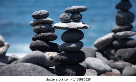 Gray Pebbles Stack With Blue Ocean In Background No People 