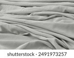 gray pillow and natural linen bed sheet