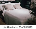 gray pillow and natural linen bed sheet