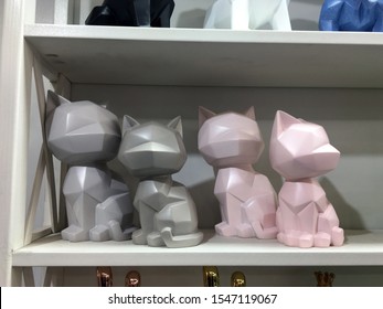 Gray and pink geometric designed ceramic cat figurine on a shelf in a decor store. Nordic style simple abstract geometric animal sculpture. Decorative items for interior - Powered by Shutterstock