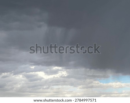Gray rainstorm clouds gathering overhead with dramatic weather atmosphere and moody sky conditions