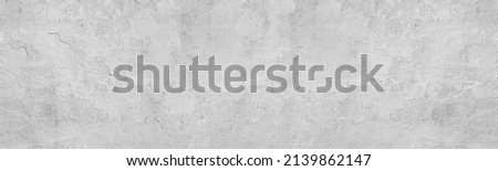 Gray shabby exterior concrete wall with peeling paint wide texture. Old cement grey surface panorama. Grunge abstract panoramic background