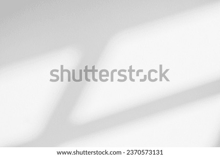 Gray shadow and light blur abstract background on white wall; from window. Dark stripe grey shadows indoor in room; background; monochrome; shadow overlay effect for backdrop and mockup design