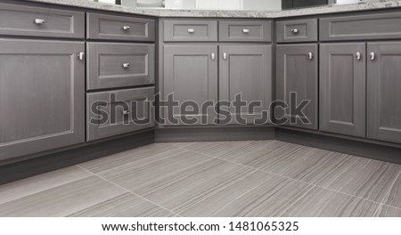 gray shaker style kitchen / vanity / bathroom cabinet with chrome color rectangular handles, porcelain floor tiles