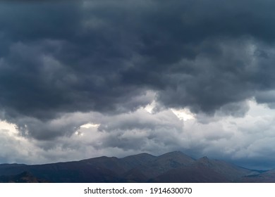 Gray sky with storm clouds over the mountains
