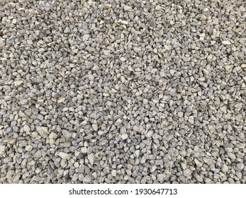 Gray small rocks ground texture. black small road stone background. gravel pebbles stone seamless texture, marble. dark background of crushed granite gravel, close up. grey clumping clay