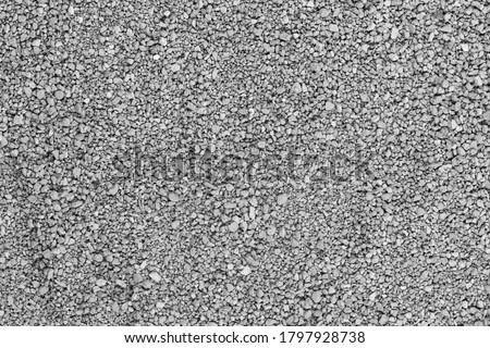 Seamless asphalt road background. Grainy floor texture with gravel  particles, small stones, black, gray and white grains. Close up, top view.  Gray asphalt pattern. Bitumen road texture Stock Photo