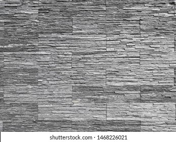Gray stone background walls are stacked. Stone cladding background and wallpaper.