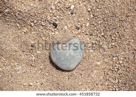 Similar – Beautiful hand holding a stone, on a beach sand background.