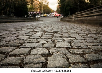 gray stone road surface, cobbled road, cobble background. texture old stone pavement in the old totwn. view in perspective.