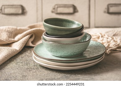 Gray stoneware plates and bowls on a rustic table - Powered by Shutterstock