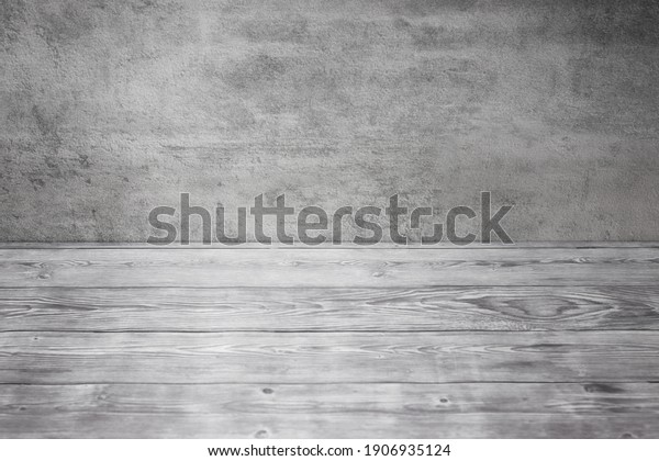 Gray studio backdrop. Wooden table and textured\
wall. Empty background\
texture.