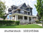 Gray Suburban style Three story tall Queen Anne style Victorian Home under Repair Remodeling