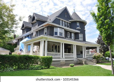 Gray Suburban Style Three Story Tall Queen Anne Style Victorian Home Under Repair Remodeling