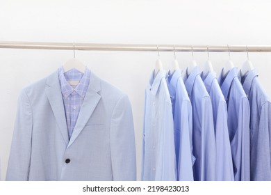 Gray Suit With Striped, Shirt And Blue ,white Dress Shirts Hanging On Hangers