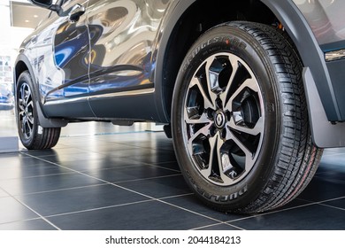Gray SUV Renault Arkana at the showroom. Bridgestone tire is mounted on cast aluminum rim. Close-up of rear left wheel. Renault car dealership in Mega Adygea. Krasnodar, Russia - August 26, 2021