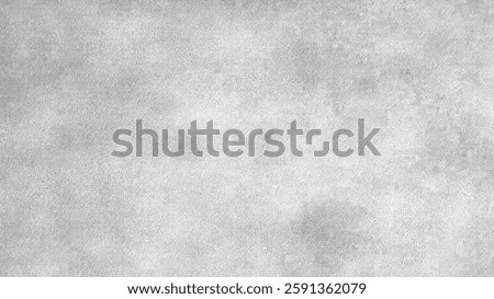 Gray textured desktop wallpaper with a subtle, mottled pattern. The gray background is ideal for desktop wallpaper use. Gray concrete textured background with copy space.