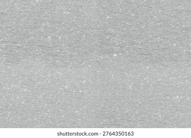 Gray textured stone background with a rough, speckled surface, creating a natural and rugged appearance.