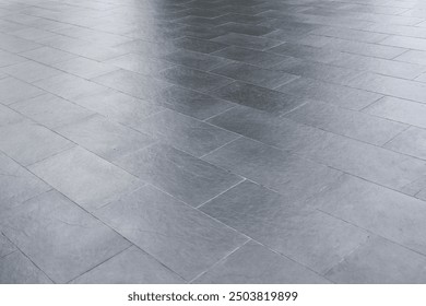 The gray tiled floor is bare and empty. The flooring around the house.
