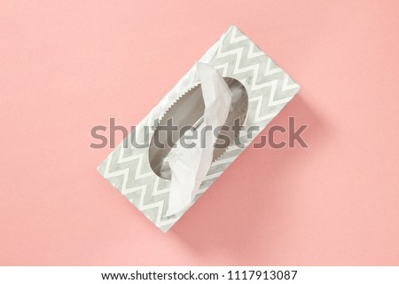 Gray tissue box on pastel pink background. Healthcare and hygiene.