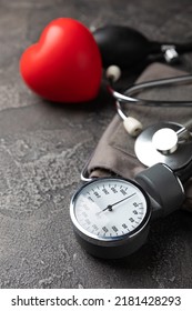 Gray Tonometer And Heart On A Black Marble Background. Medical Equipment Blood Pressure Monitor. Healthcare. Place For Text. Medicine Concept. The Concept Of Cardiology.